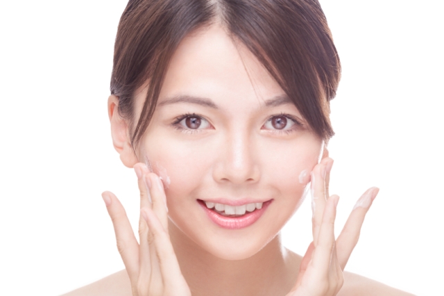 Asian Woman Applying Face Cream